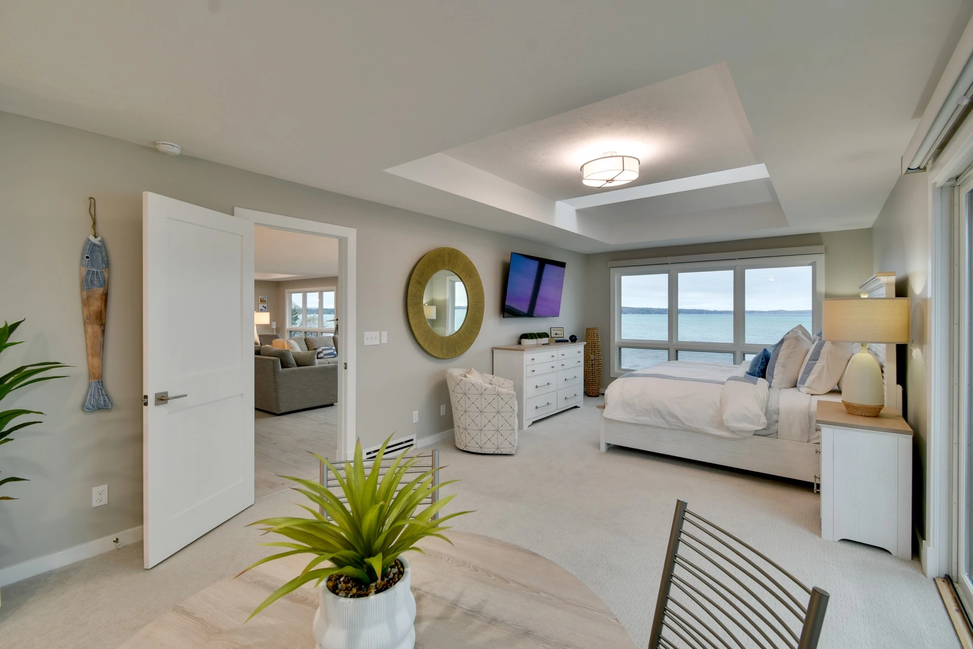 a bedroom with a large window overlooking the ocean