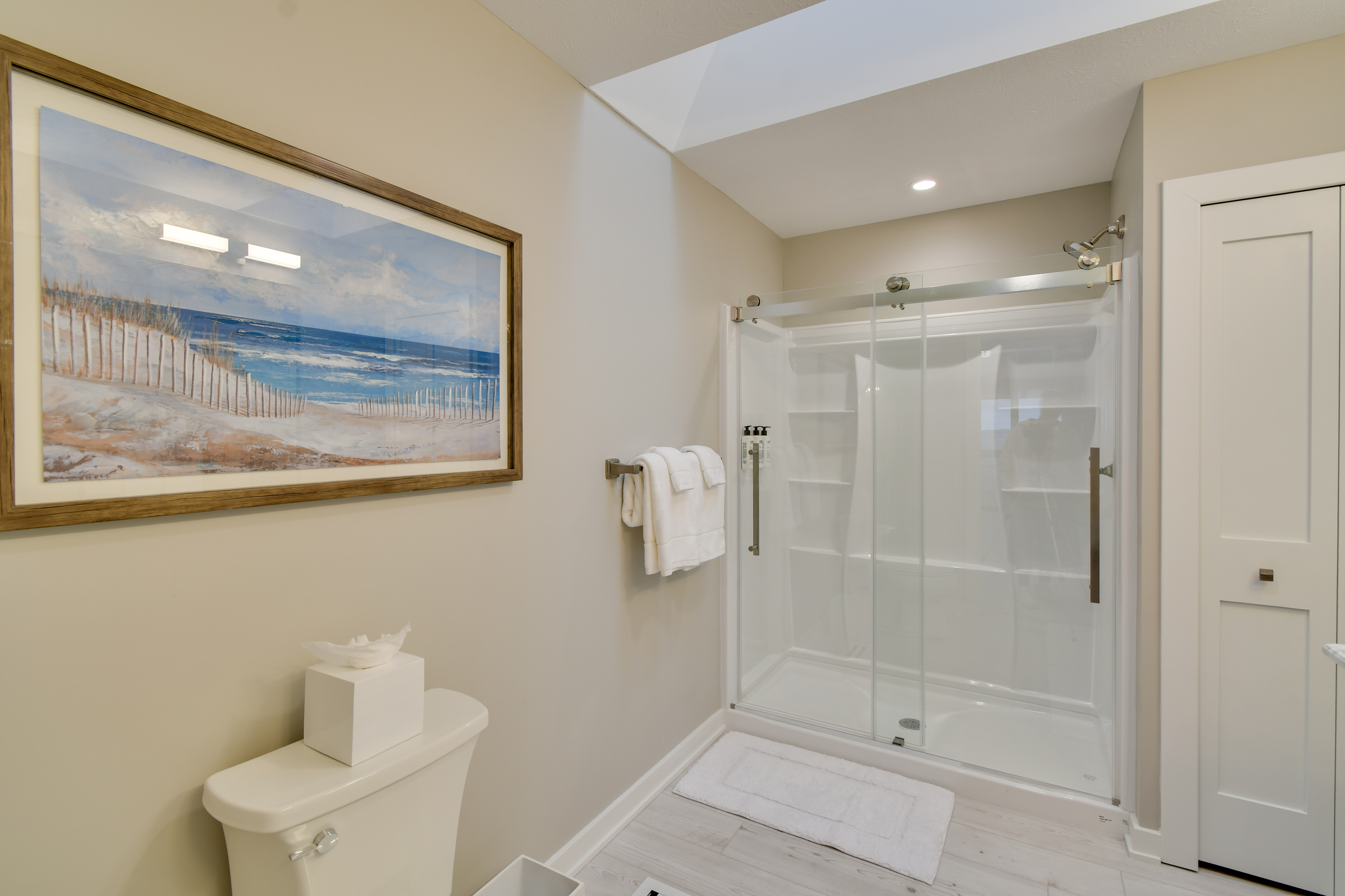 a bathroom with a glass shower and a toilet