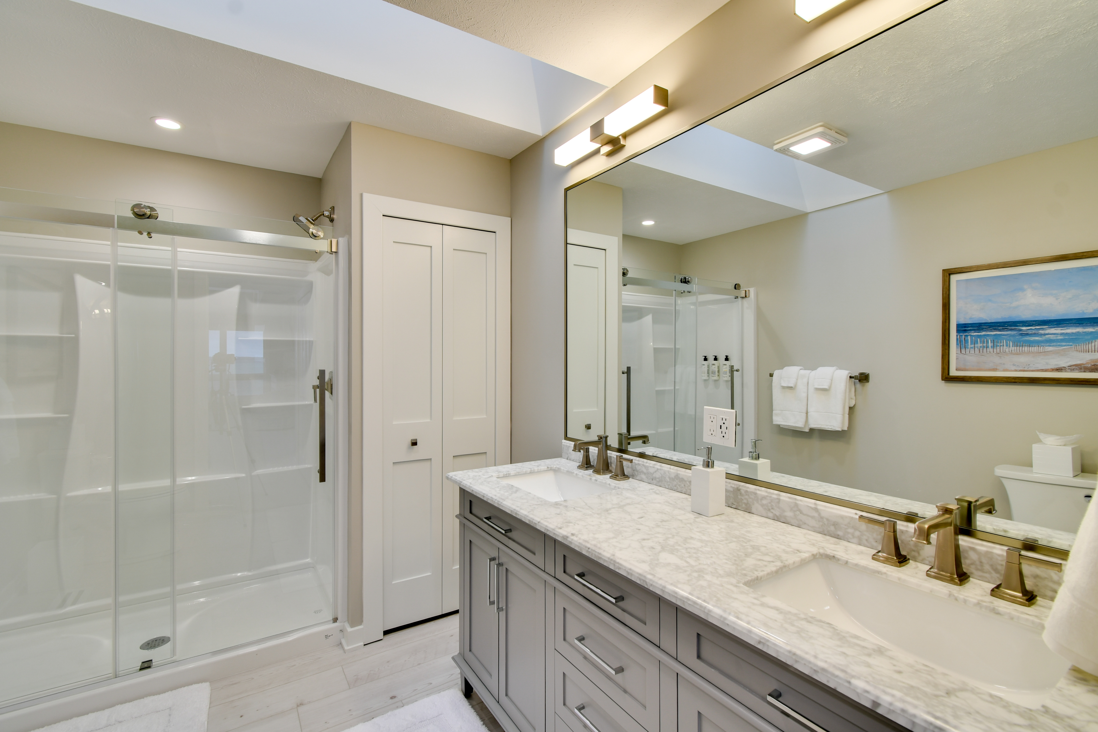 a bathroom with a large mirror and a shower