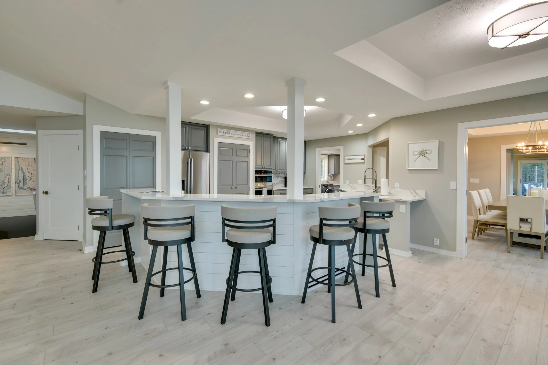 a kitchen with a bar and stools
