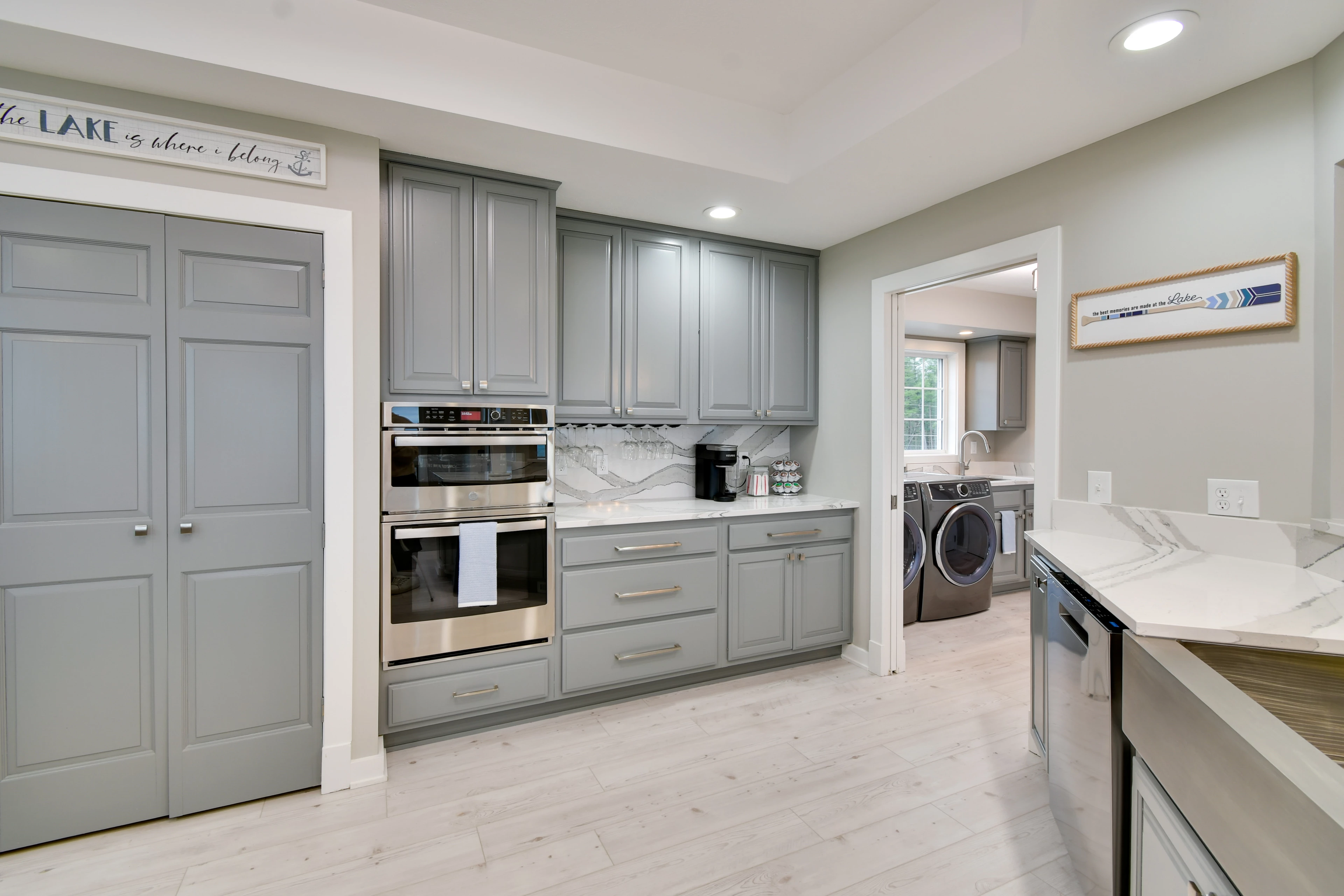 a kitchen with grey cabinets and appliances