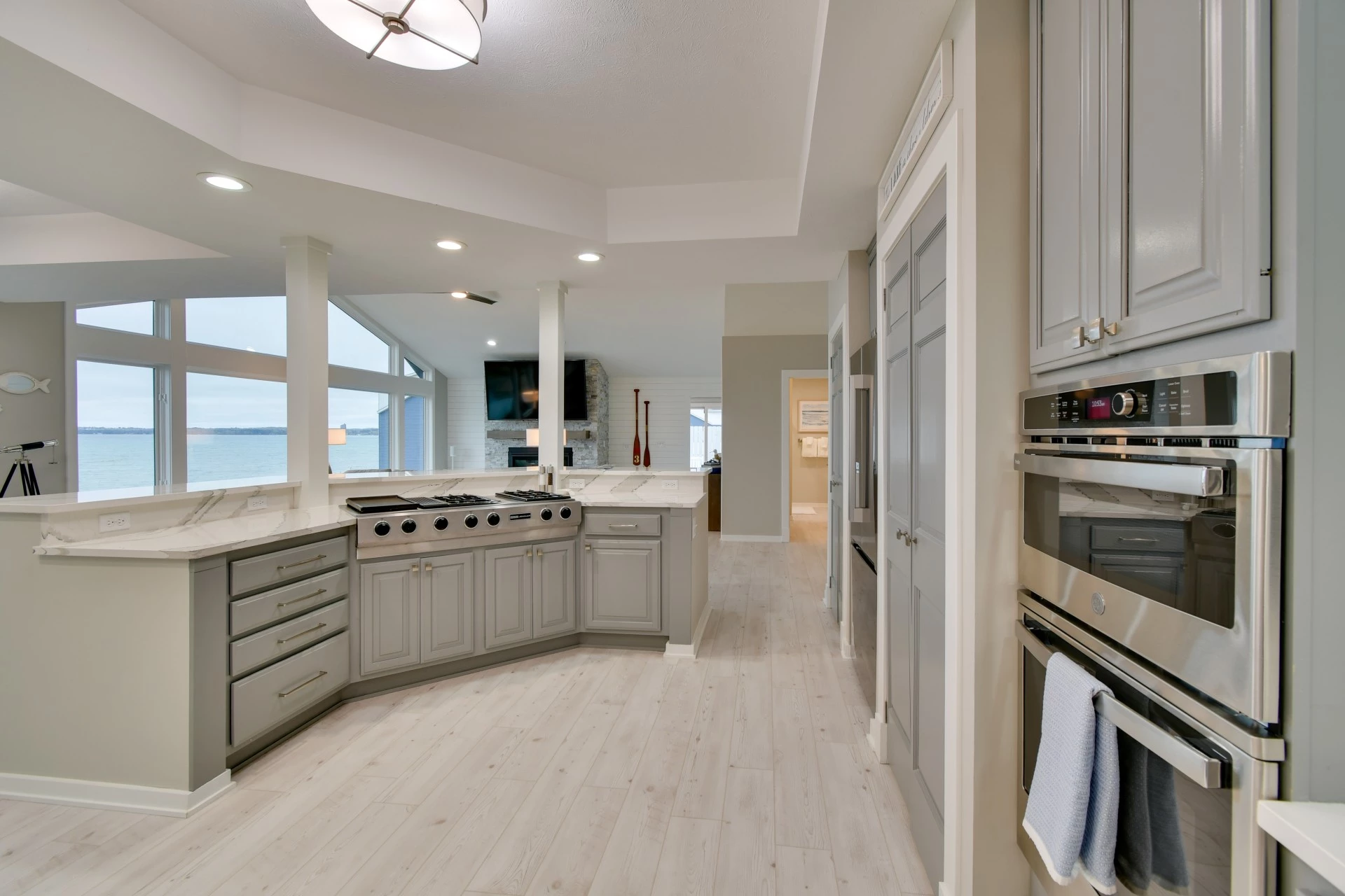 a kitchen with a large island and a large window