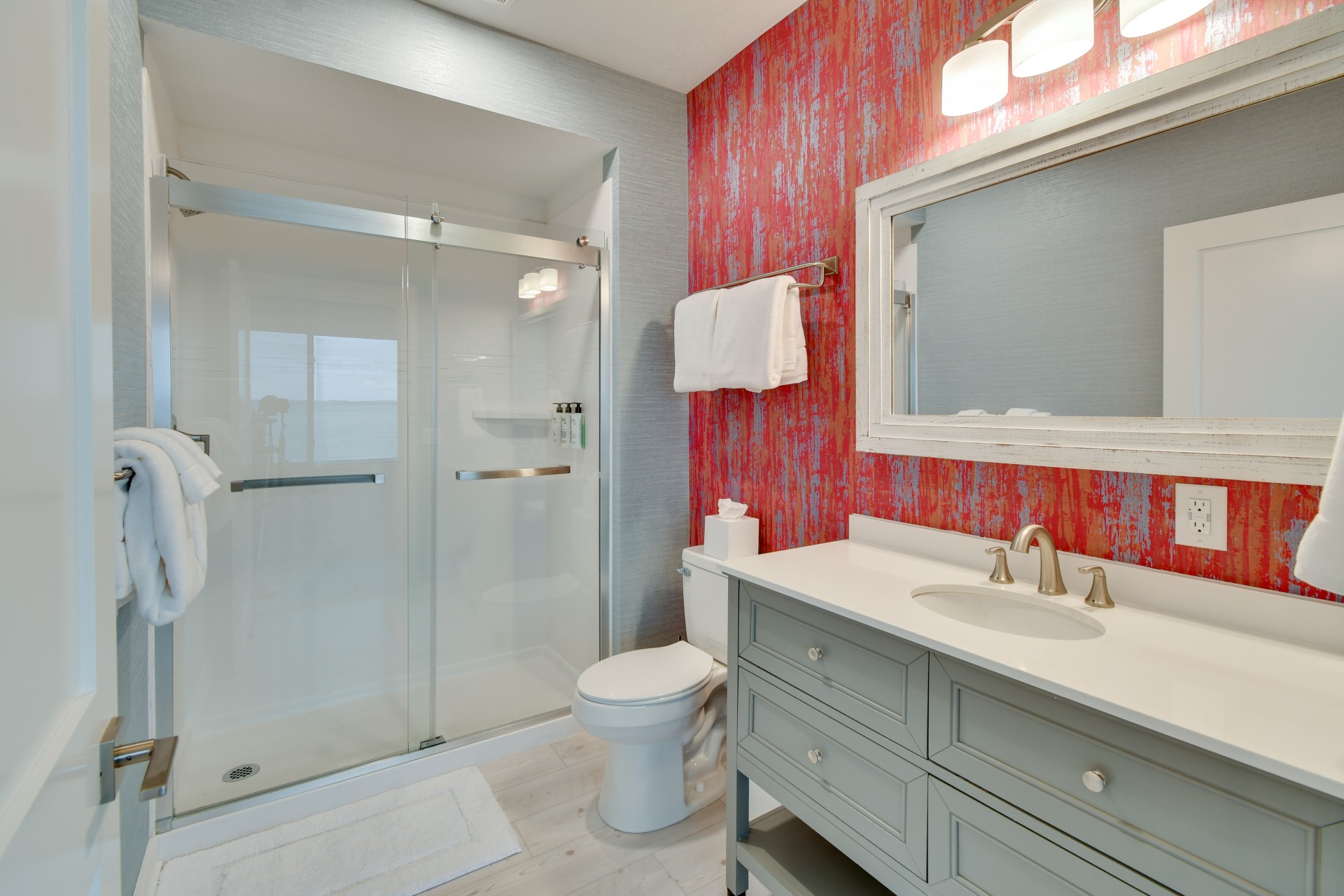 a bathroom with a glass shower and sink