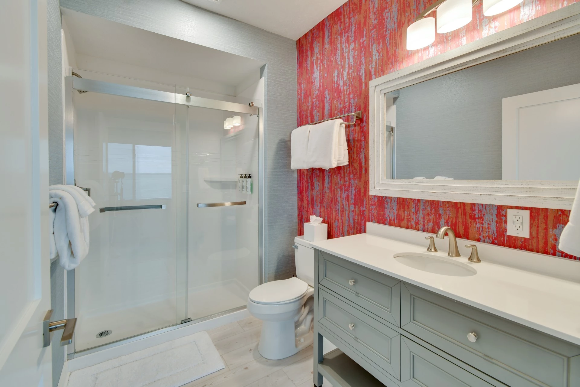 a bathroom with a glass shower and sink