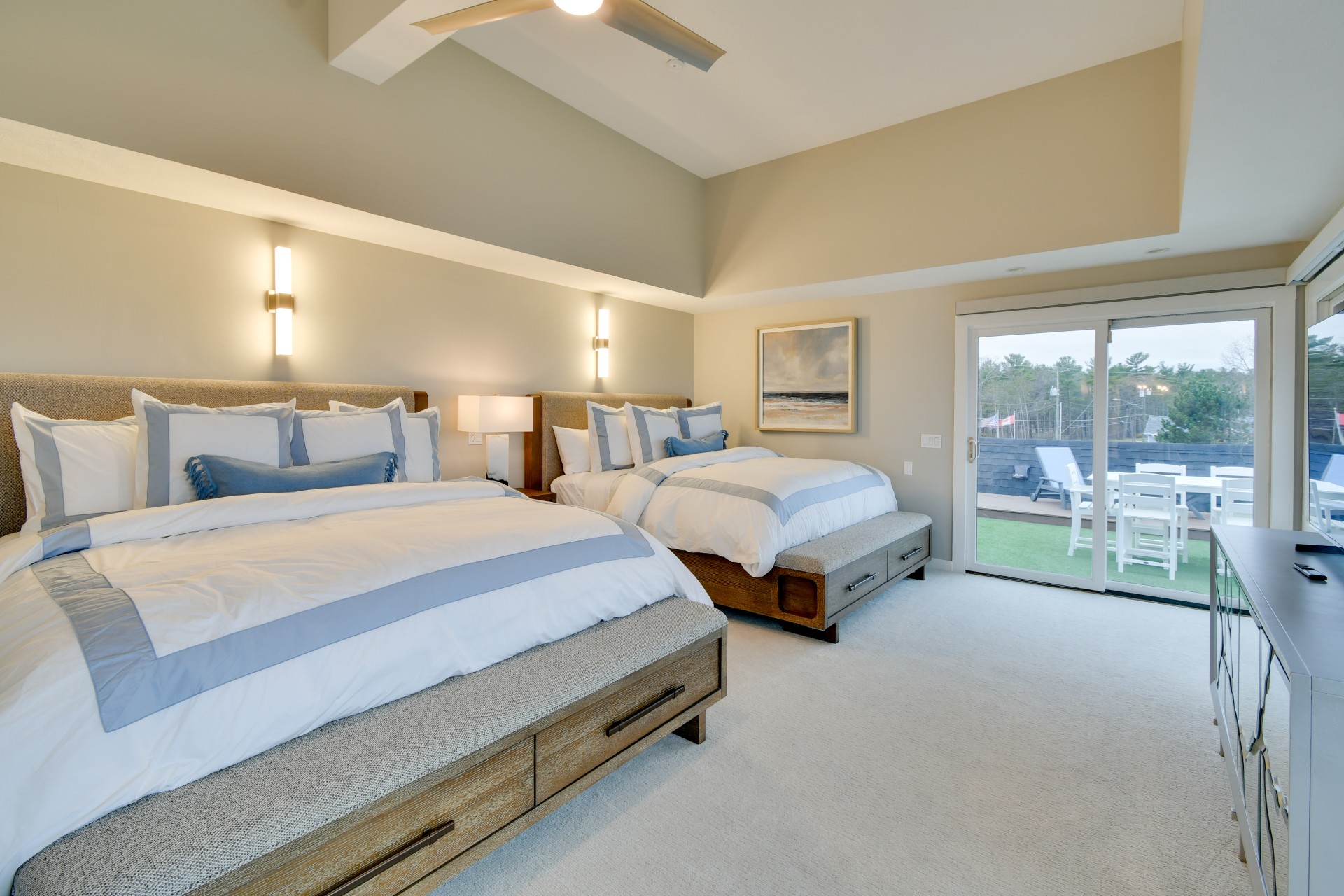 a room with two beds and a glass door