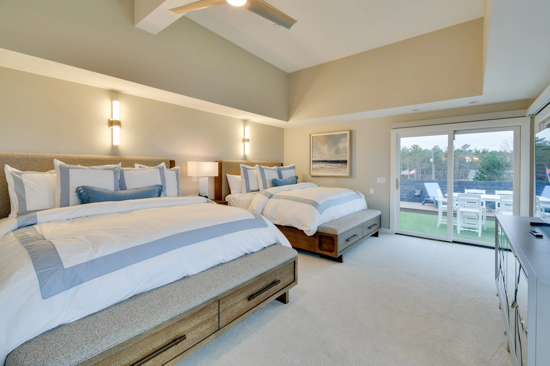 a room with two beds and a glass door