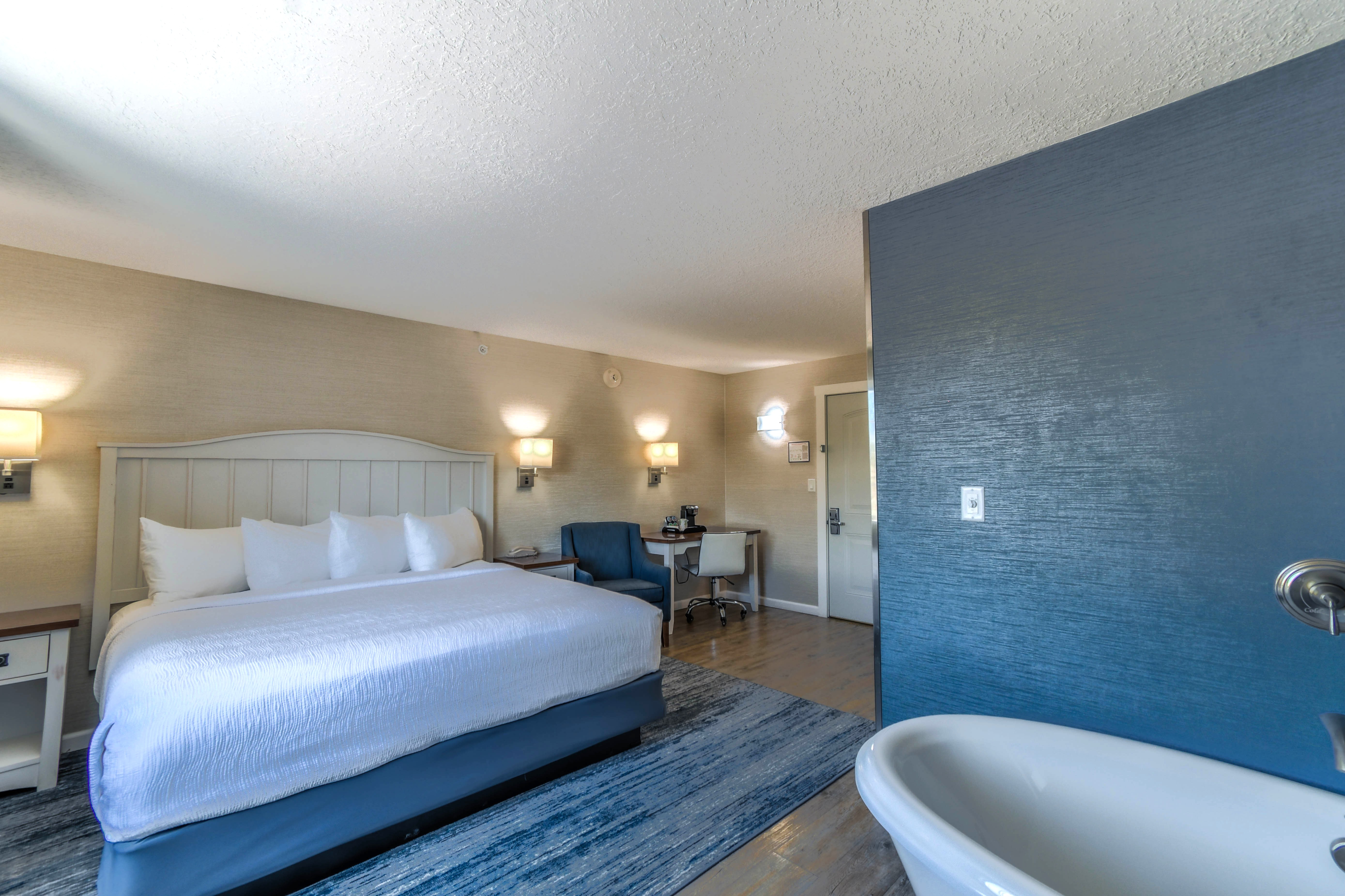 a room with a bed and a tub