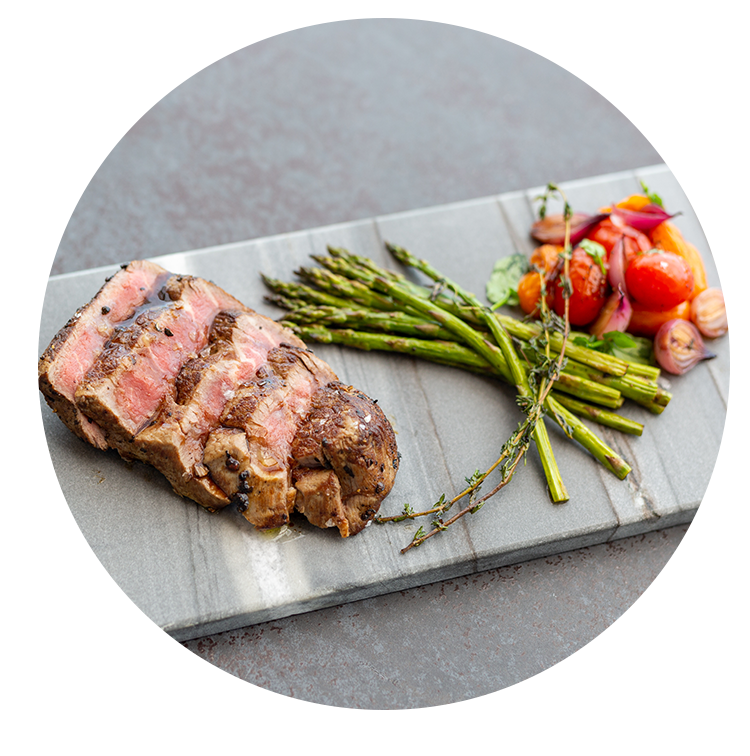 a steak and vegetables on a cutting board