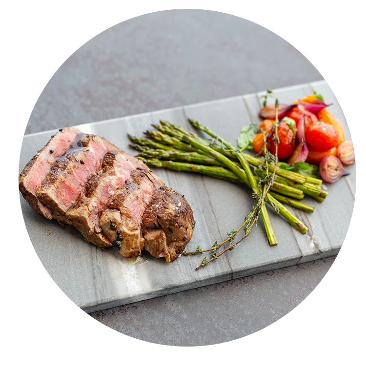 a steak and vegetables on a cutting board