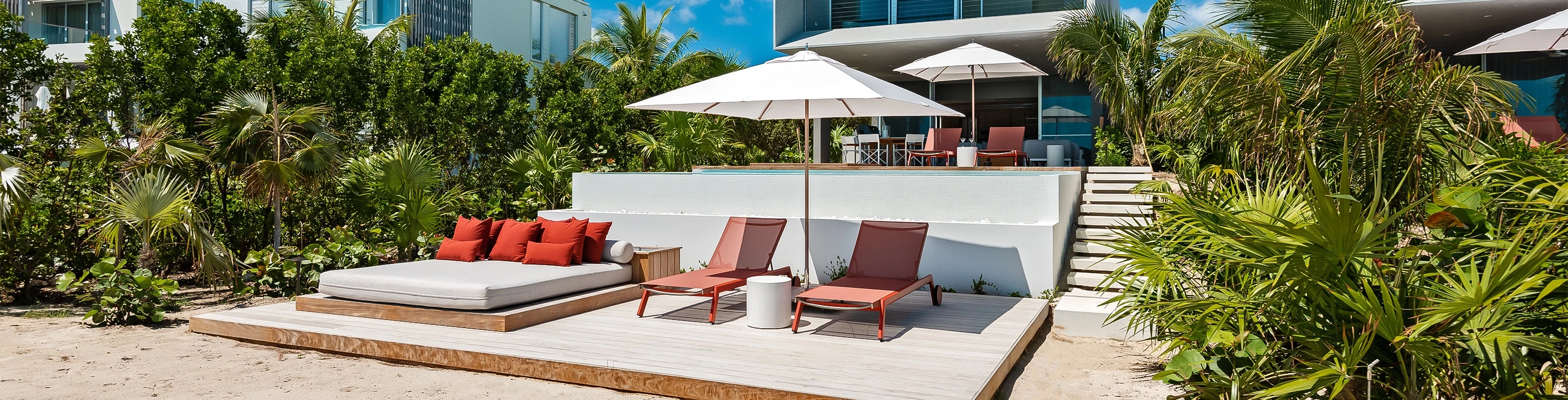 a patio with chairs and umbrellas