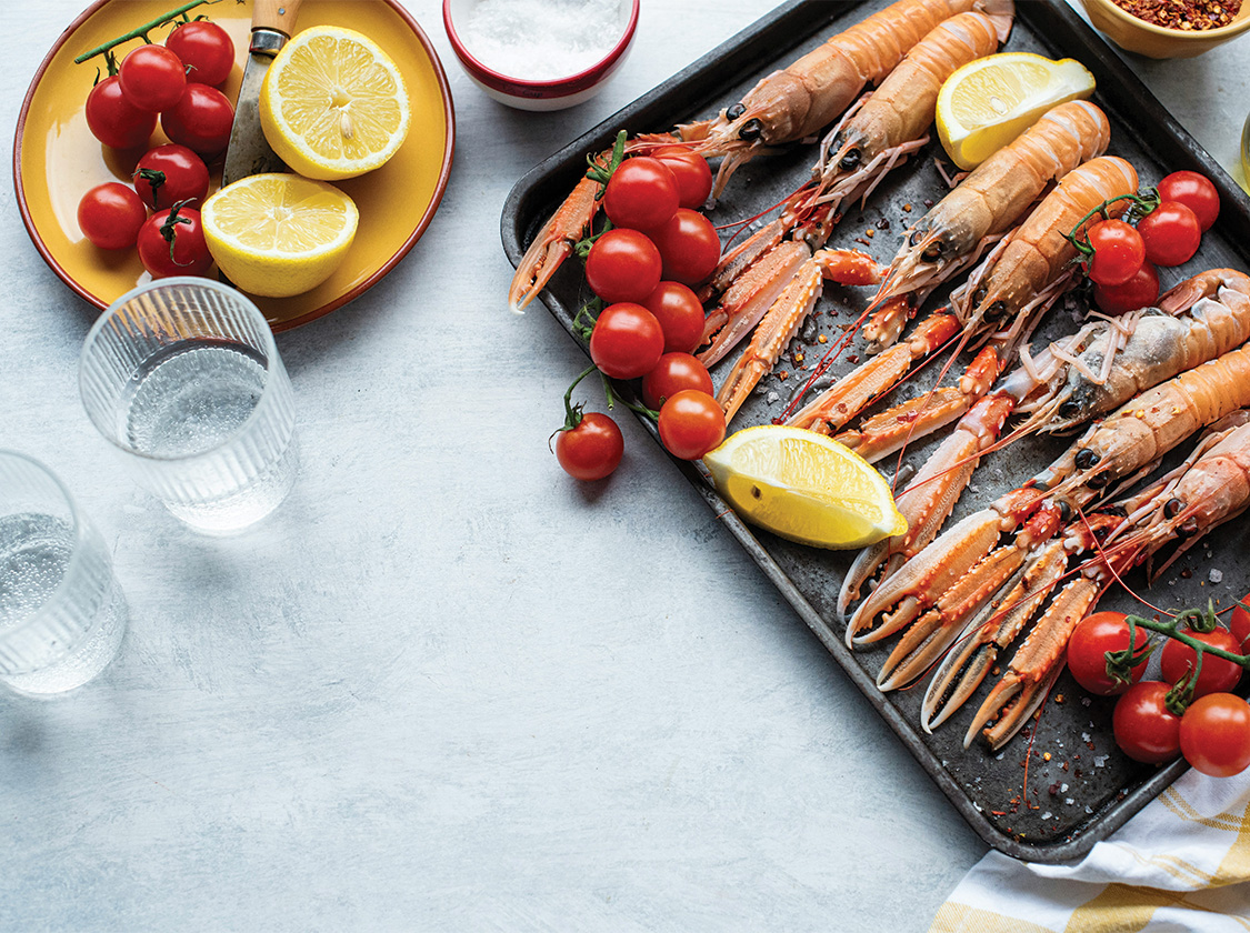 a tray of seafood and lemons
