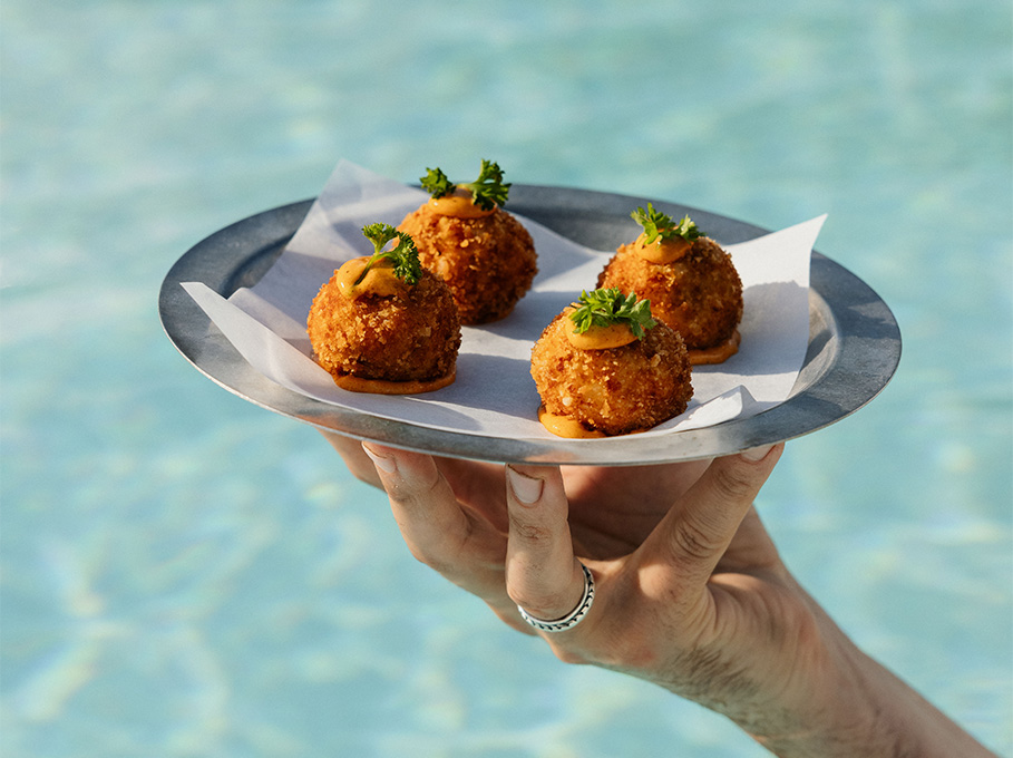 a hand holding a plate of food