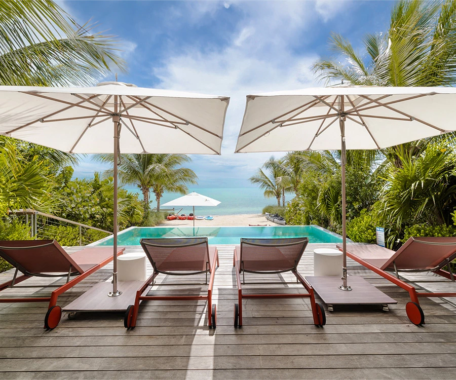a pool with lounge chairs and umbrellas