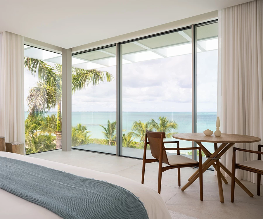 a room with a bed and a table and chairs