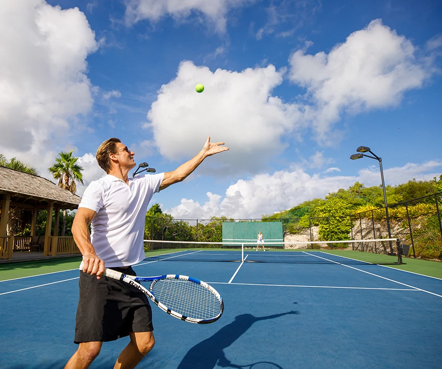 a man playing tennis on a tennis court