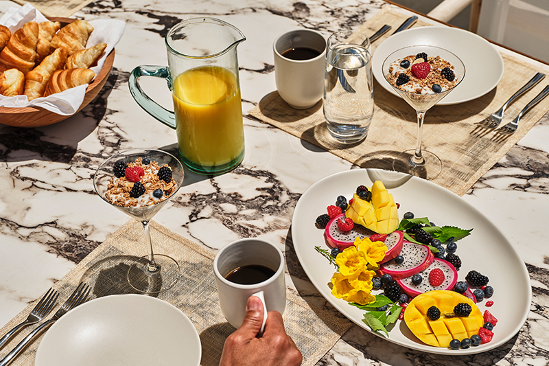 a table with plates of food and drinks