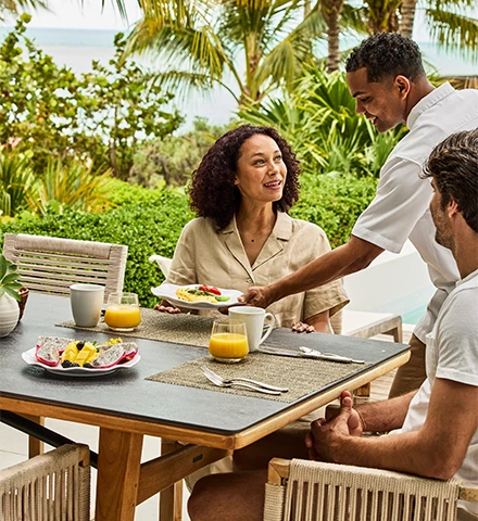 a man serving food to a woman