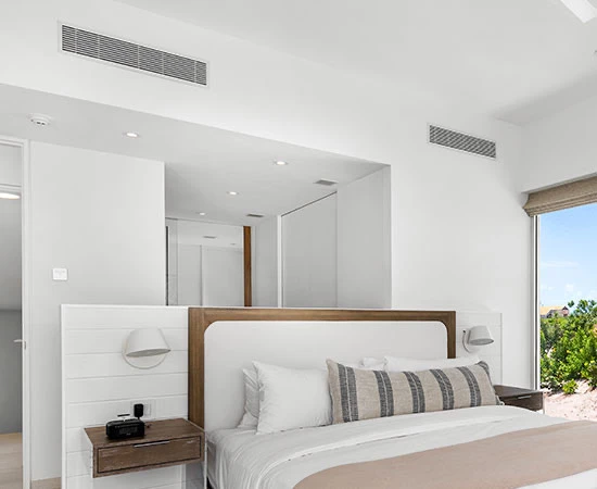 a bedroom with a large mirror