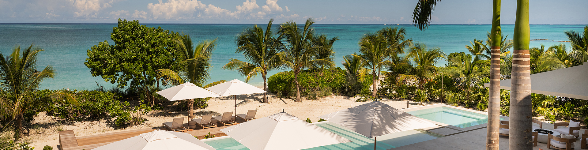 a beach with palm trees and umbrellas