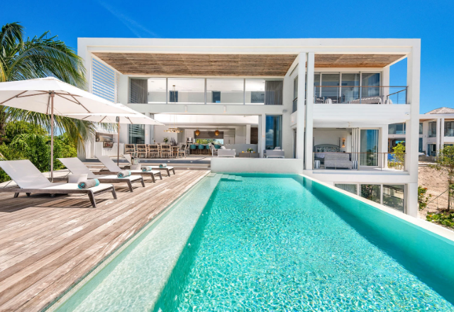 a pool with lounge chairs and a deck