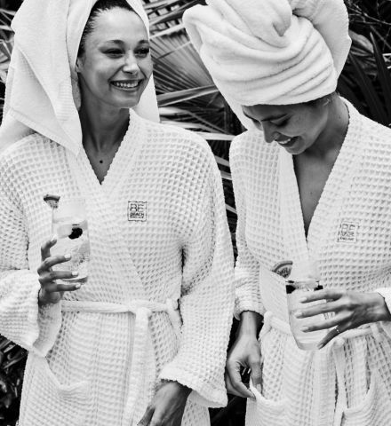 a couple of women wearing white robes