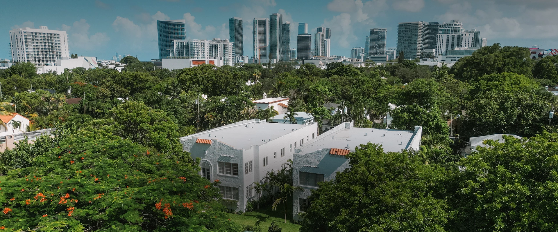 a group of buildings with trees in the background