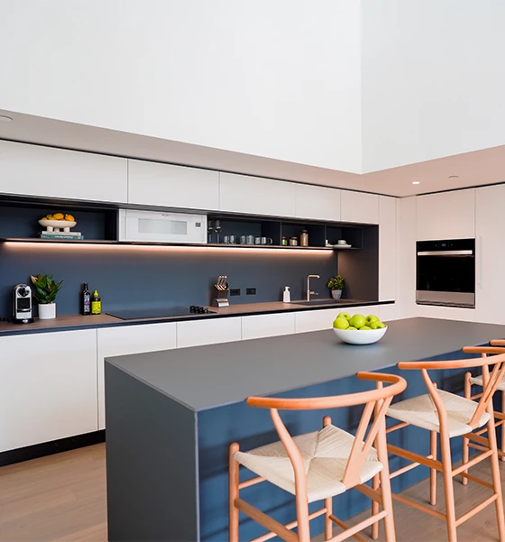 a kitchen with a large island and chairs