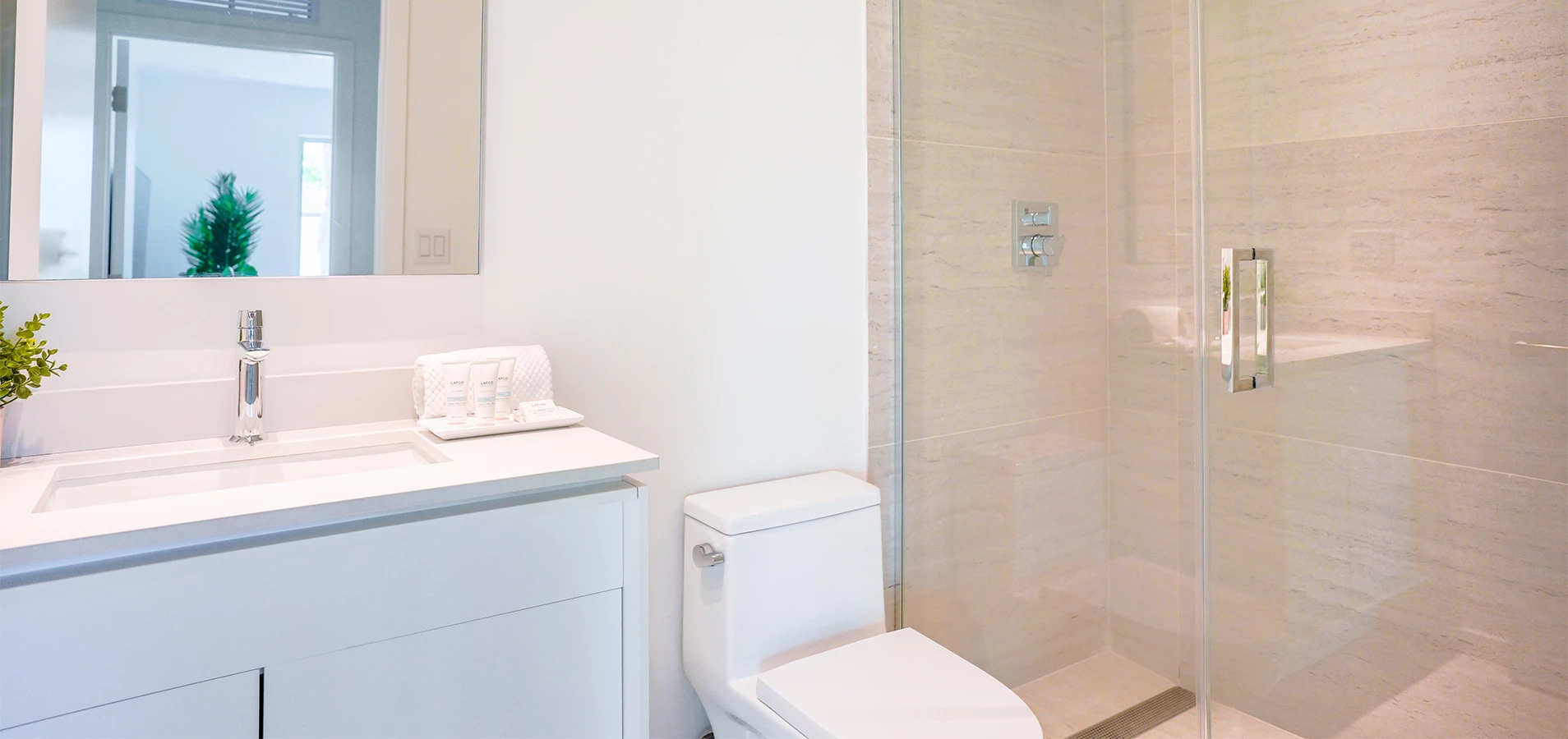 a bathroom with a glass shower and toilet
