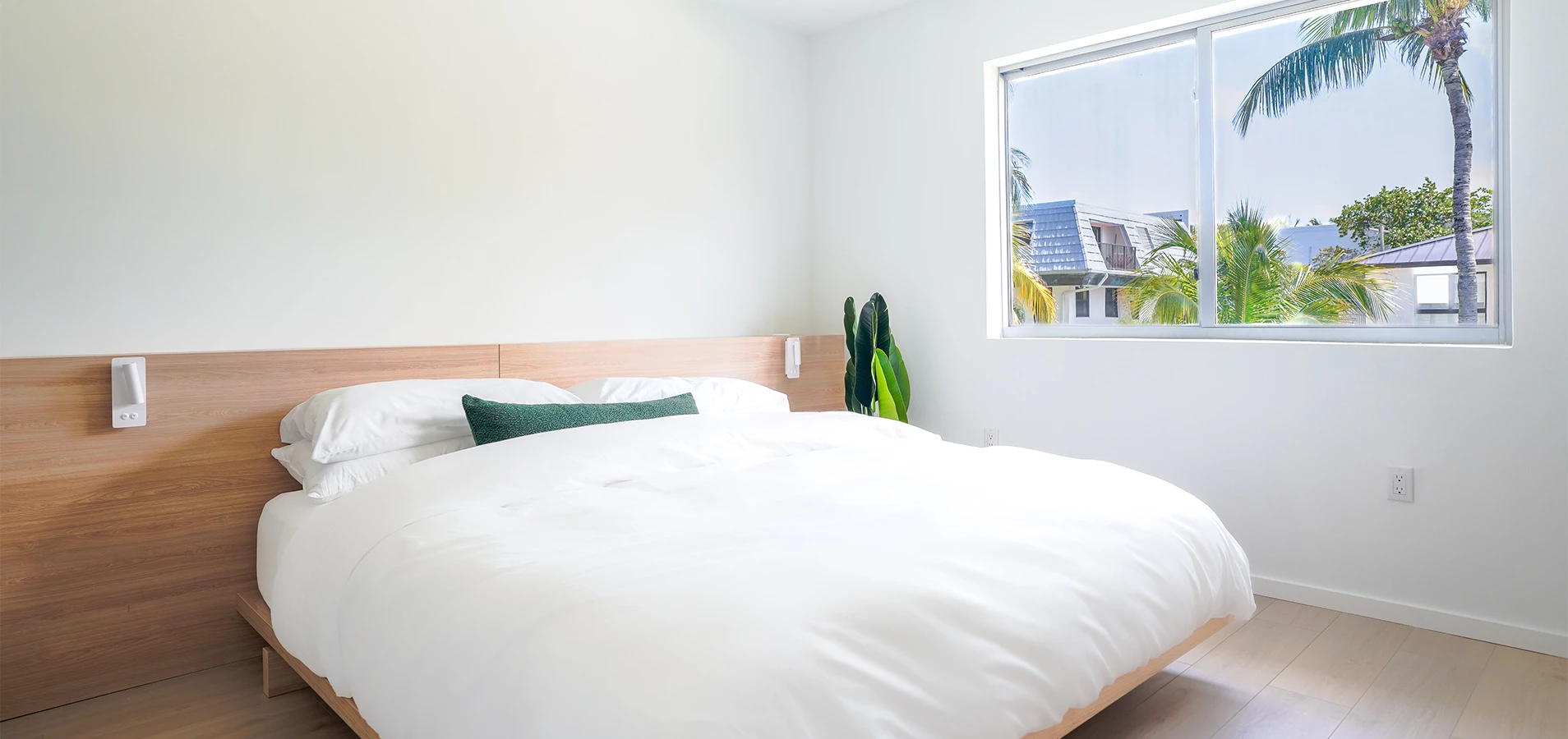 a bed with a window and plant