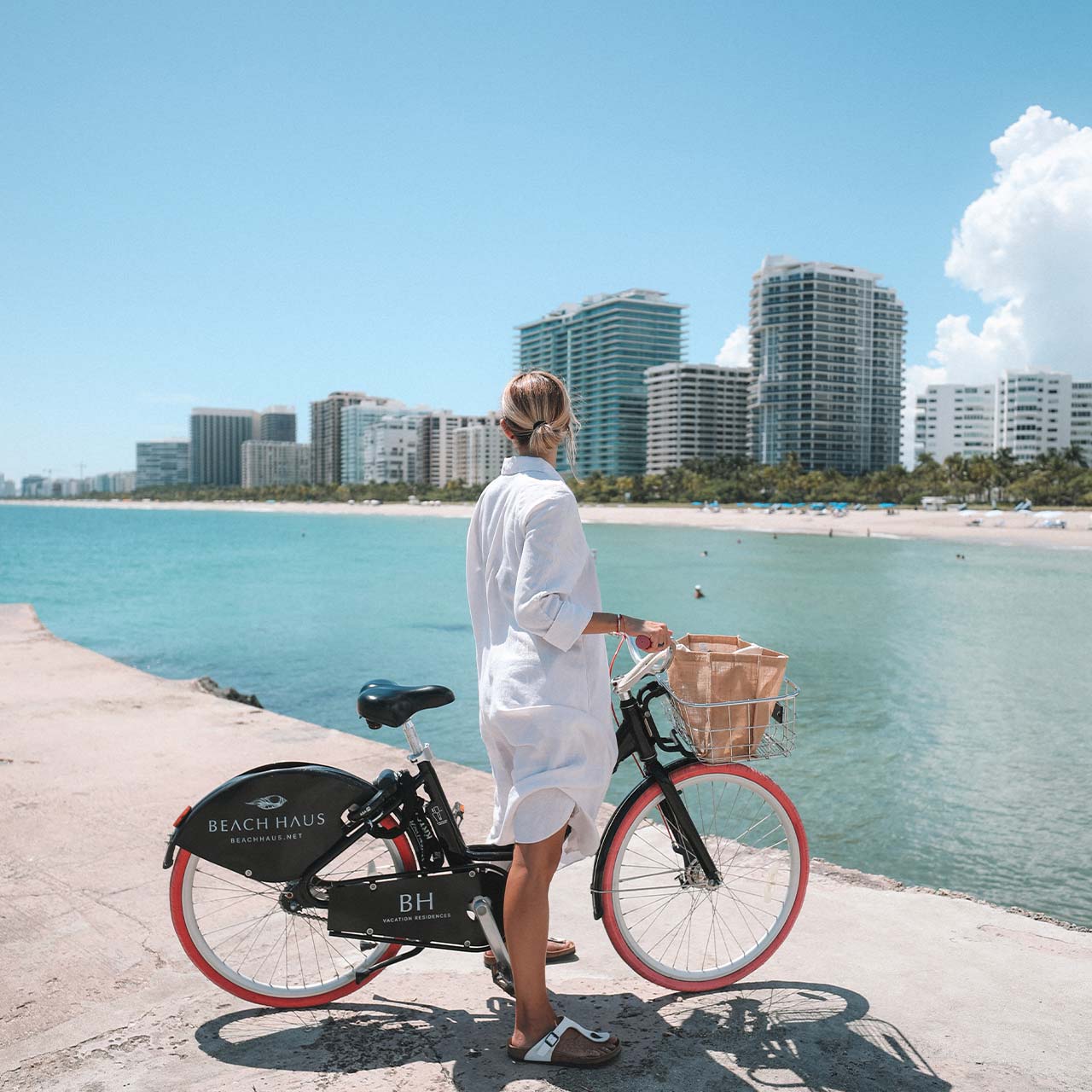 a woman standing next to a bicycle