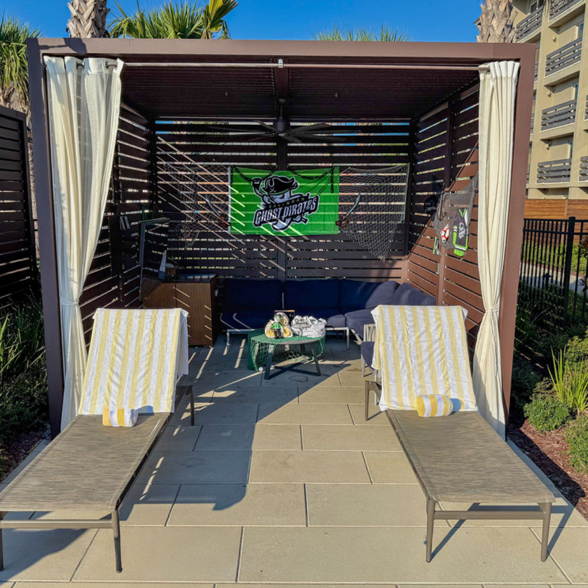 a patio with lounge chairs and a table