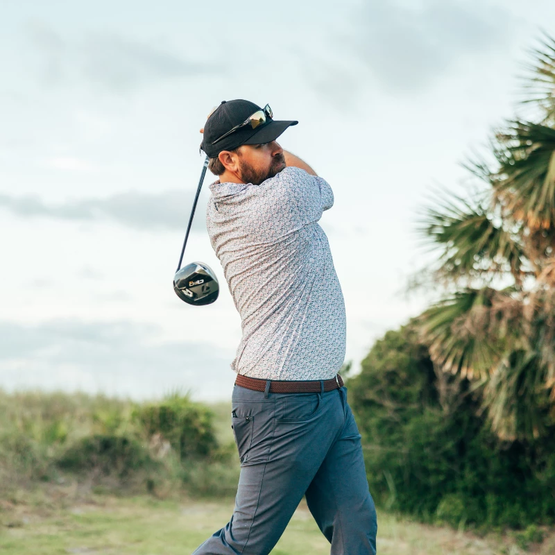 a man swinging a golf club