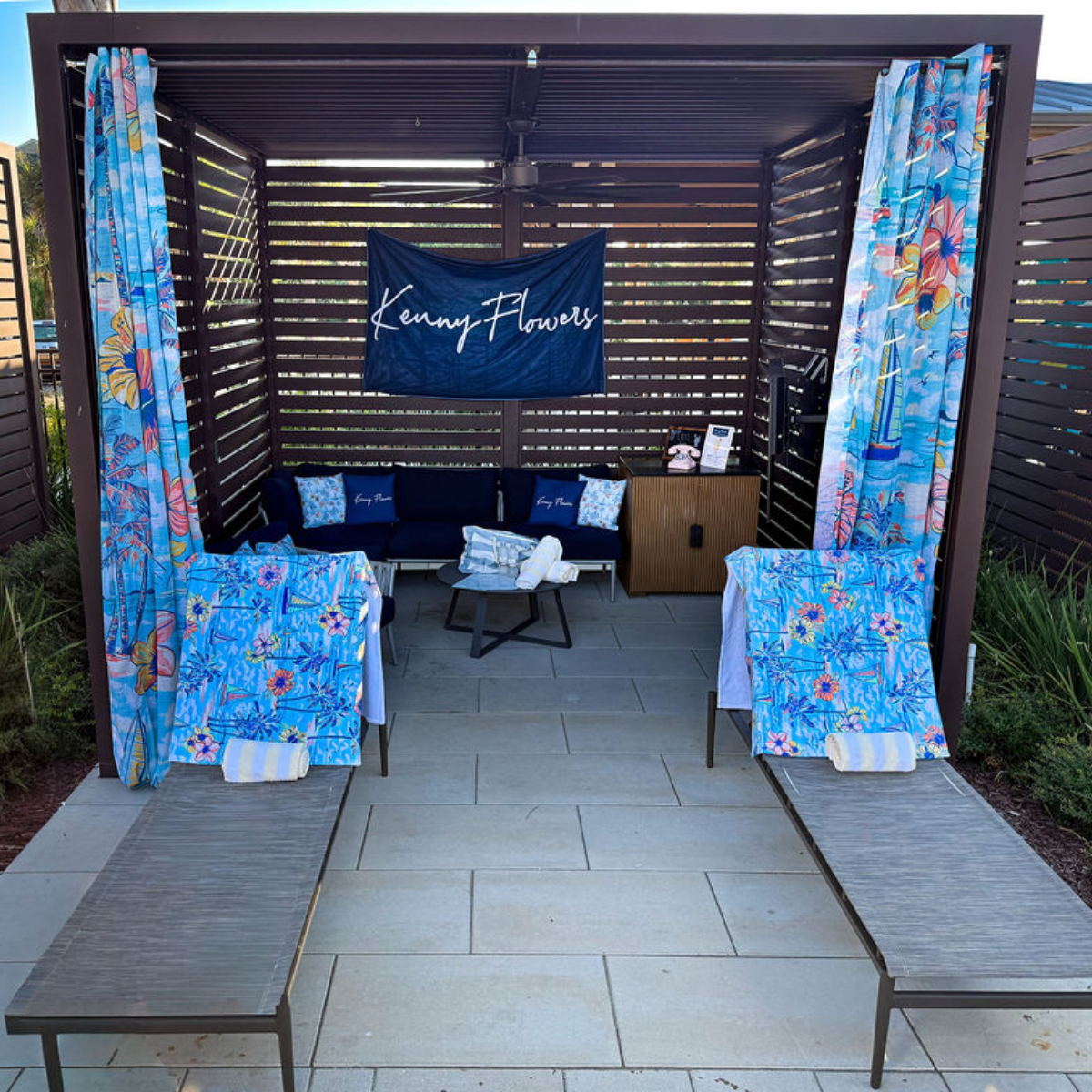 a gazebo with a blue and white blanket and chairs