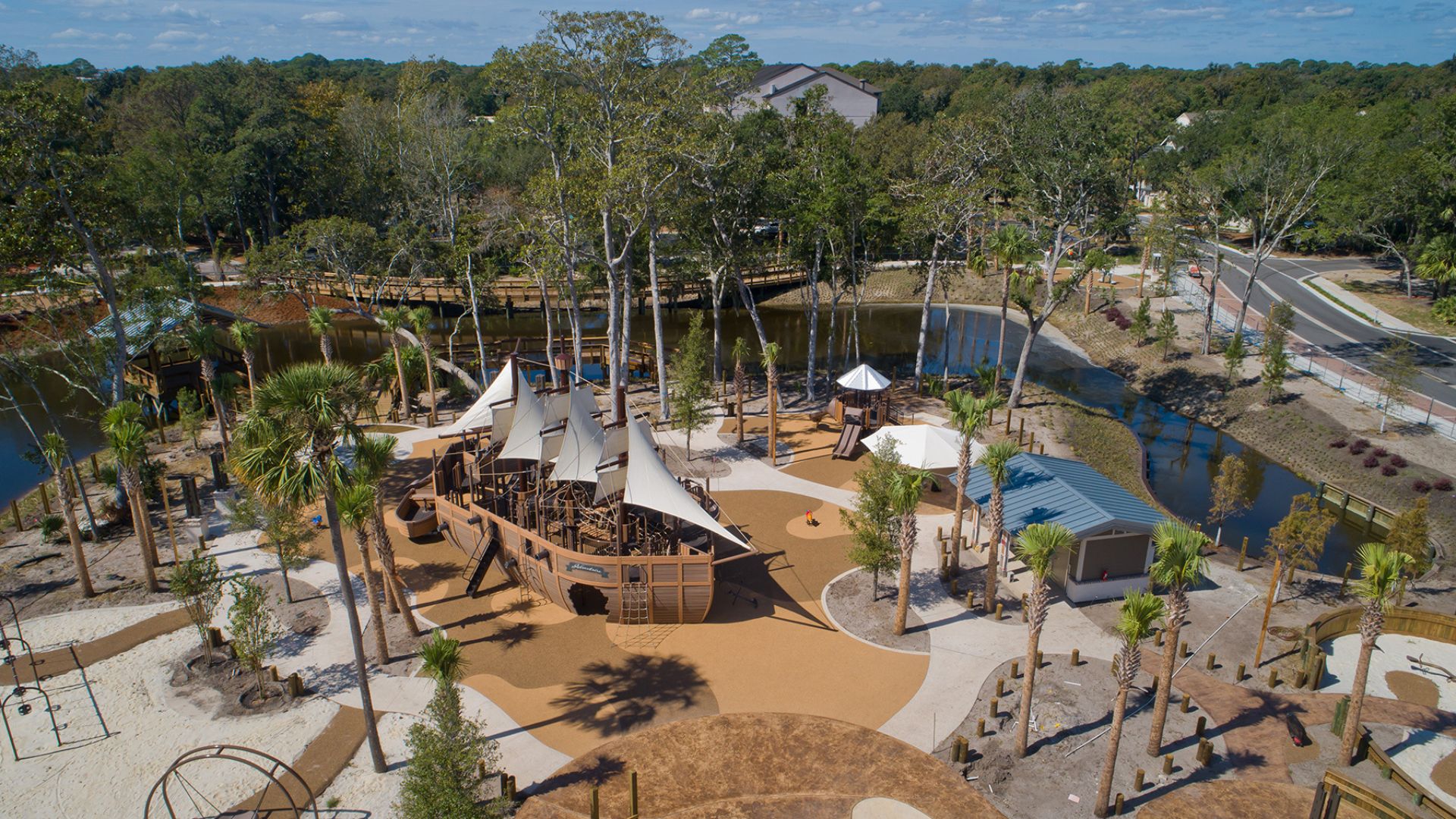 a playground with a boat and trees