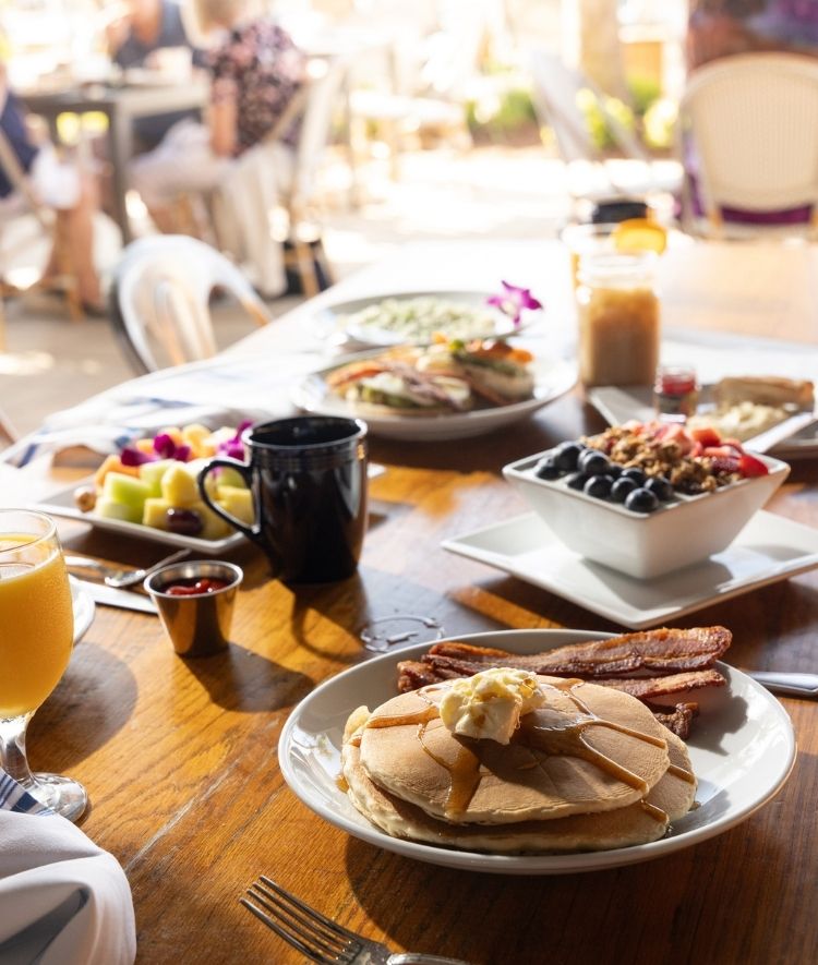 a table with plates of food and drinks