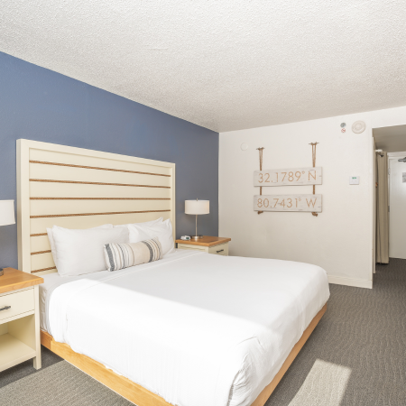 a bedroom with a bed and a lamp