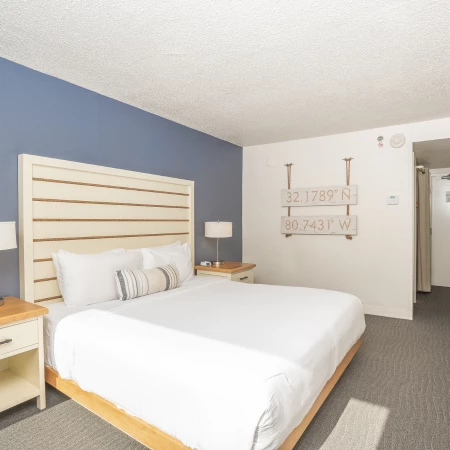 a bedroom with a bed and a lamp