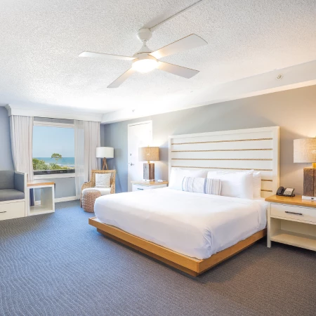 a room with a bed and a ceiling fan