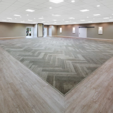 a large room with a door and a wood floor