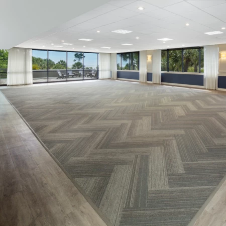 a large room with a wood floor and windows