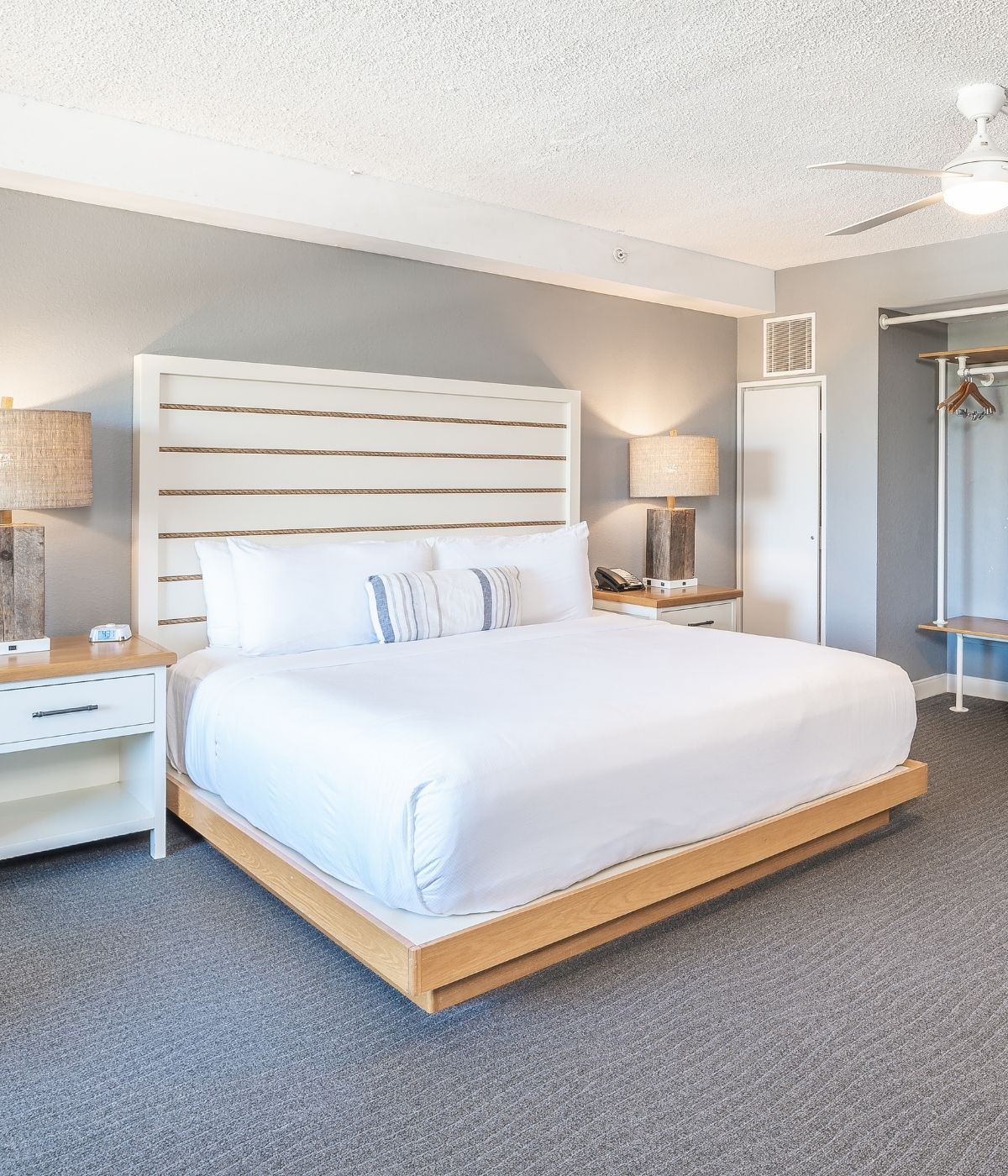 a bedroom with a bed and a fan