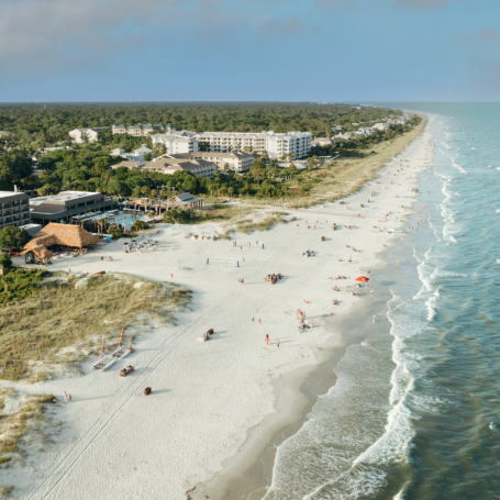 a beach with buildings and trees