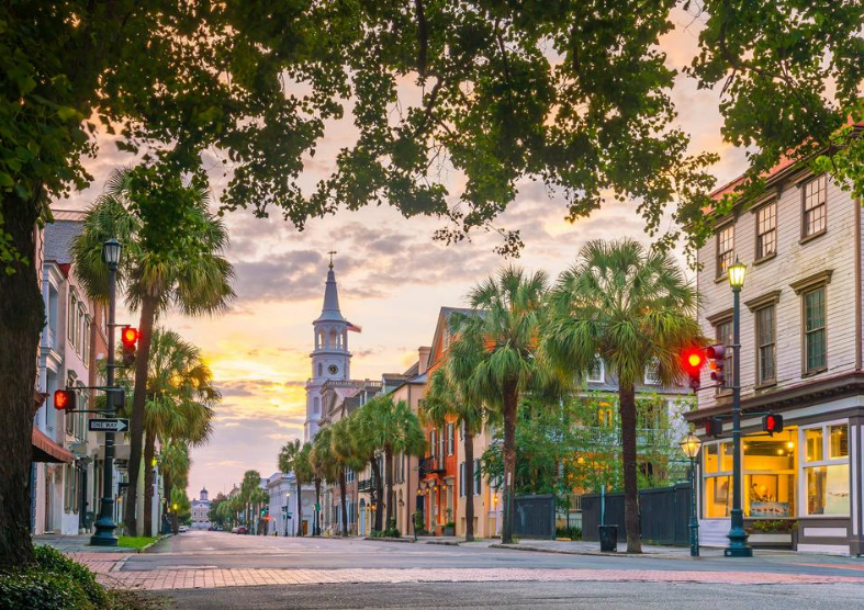 a street with palm trees and a church on the side