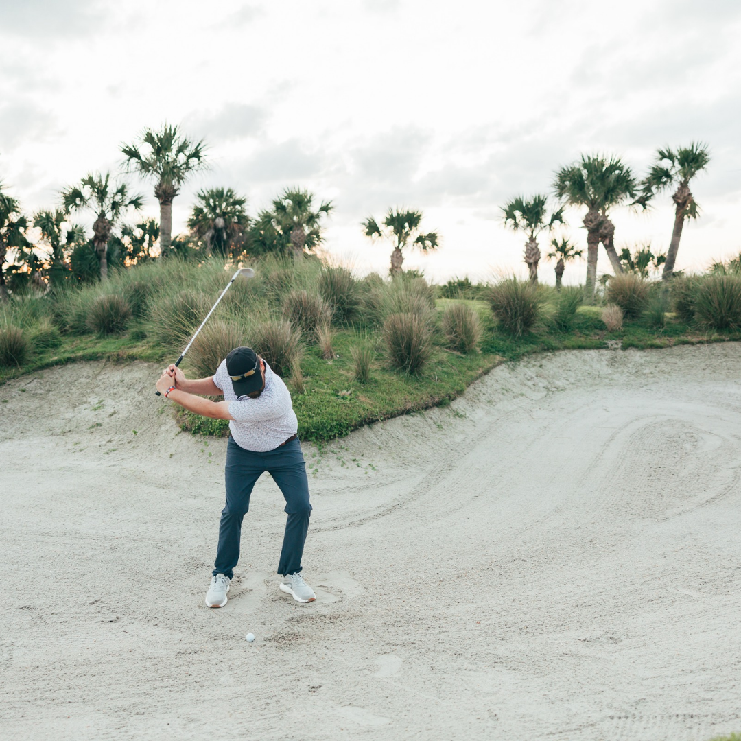 a person swinging a golf club