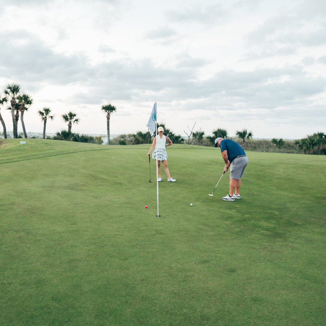 a man and woman playing golf