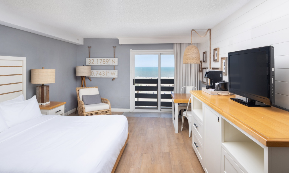 a room with a bed and a television