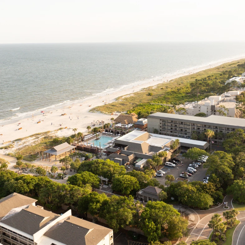 a beach with buildings and trees
