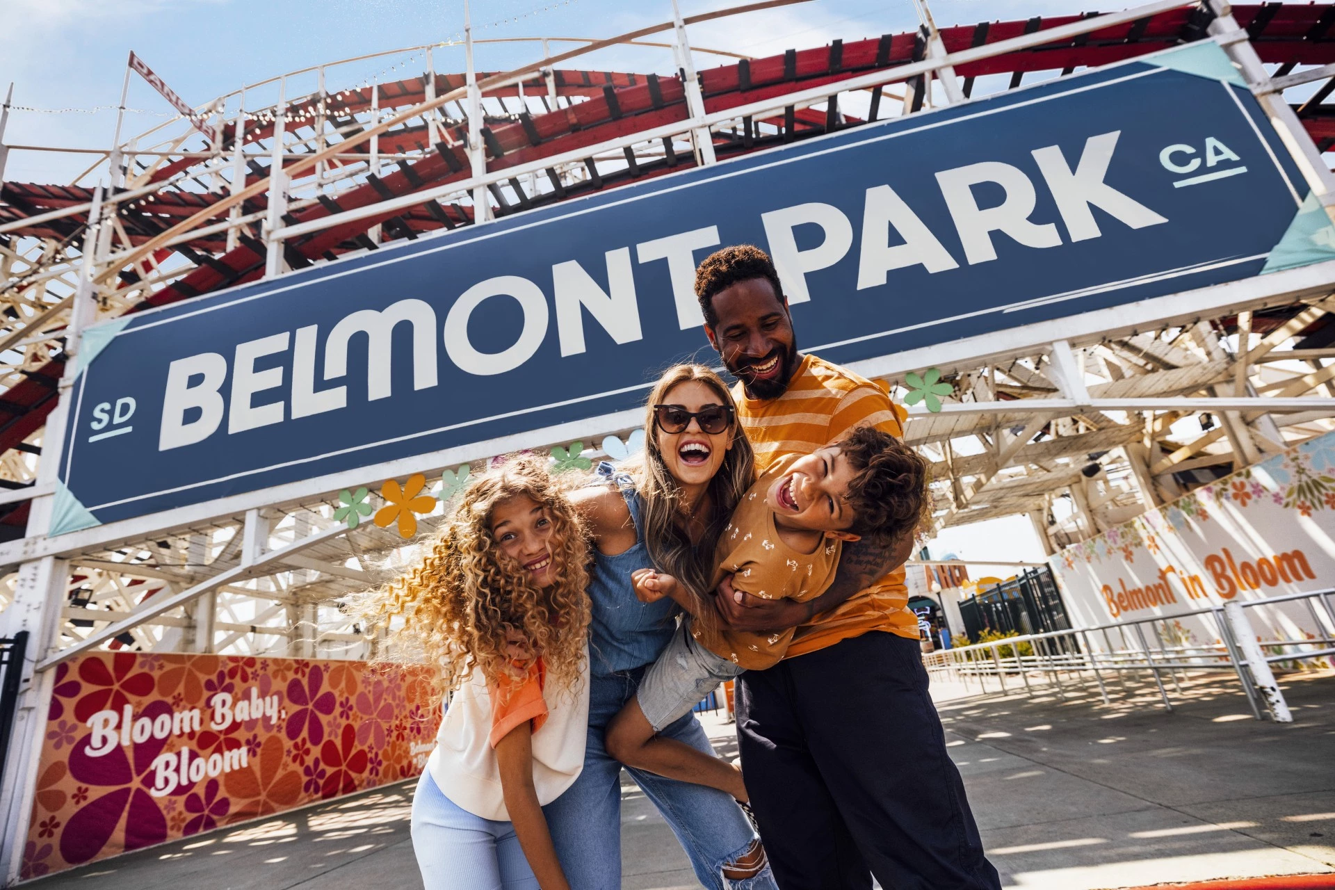a family posing for a picture in front of Belmont Park
