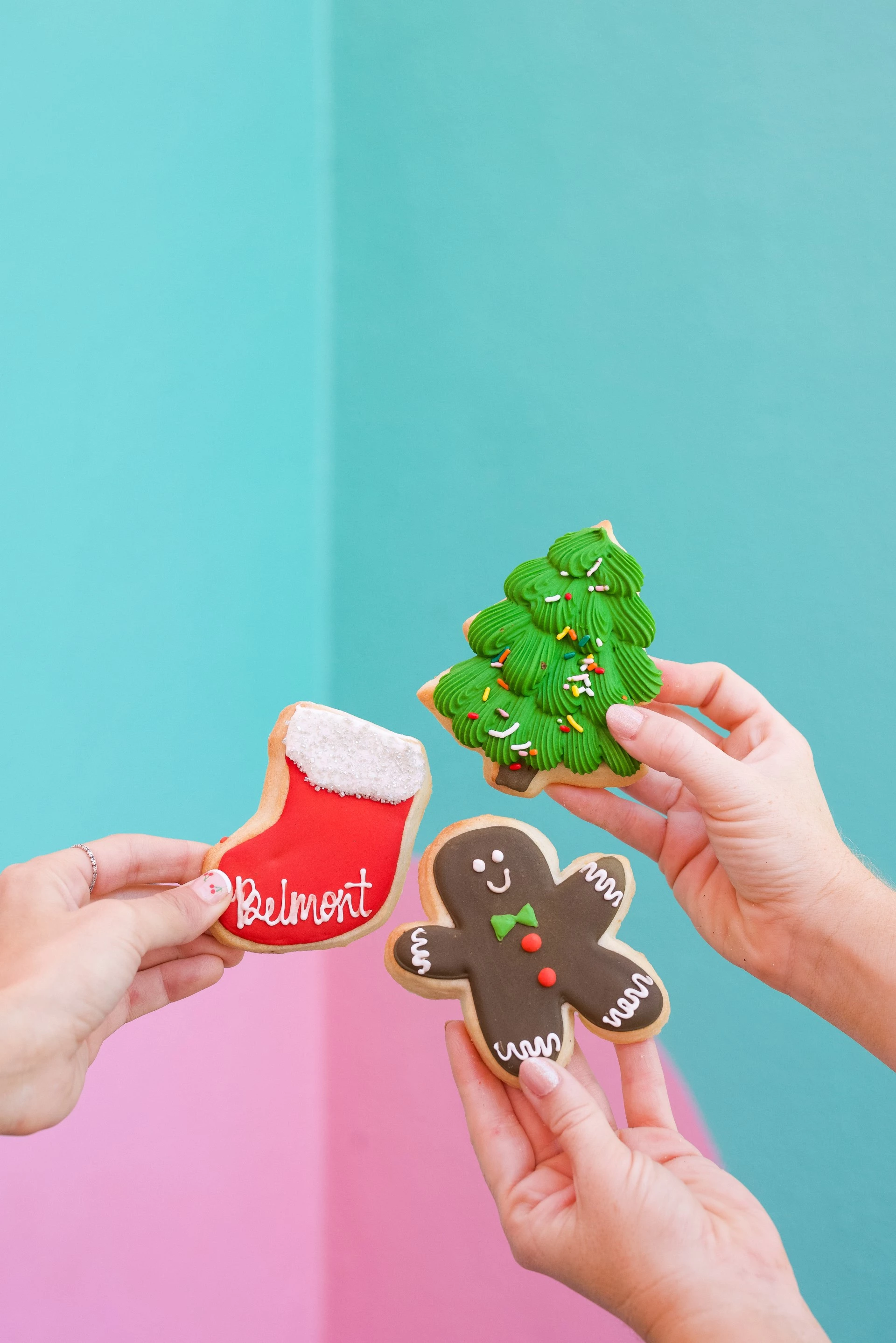 a group of hands holding cookies