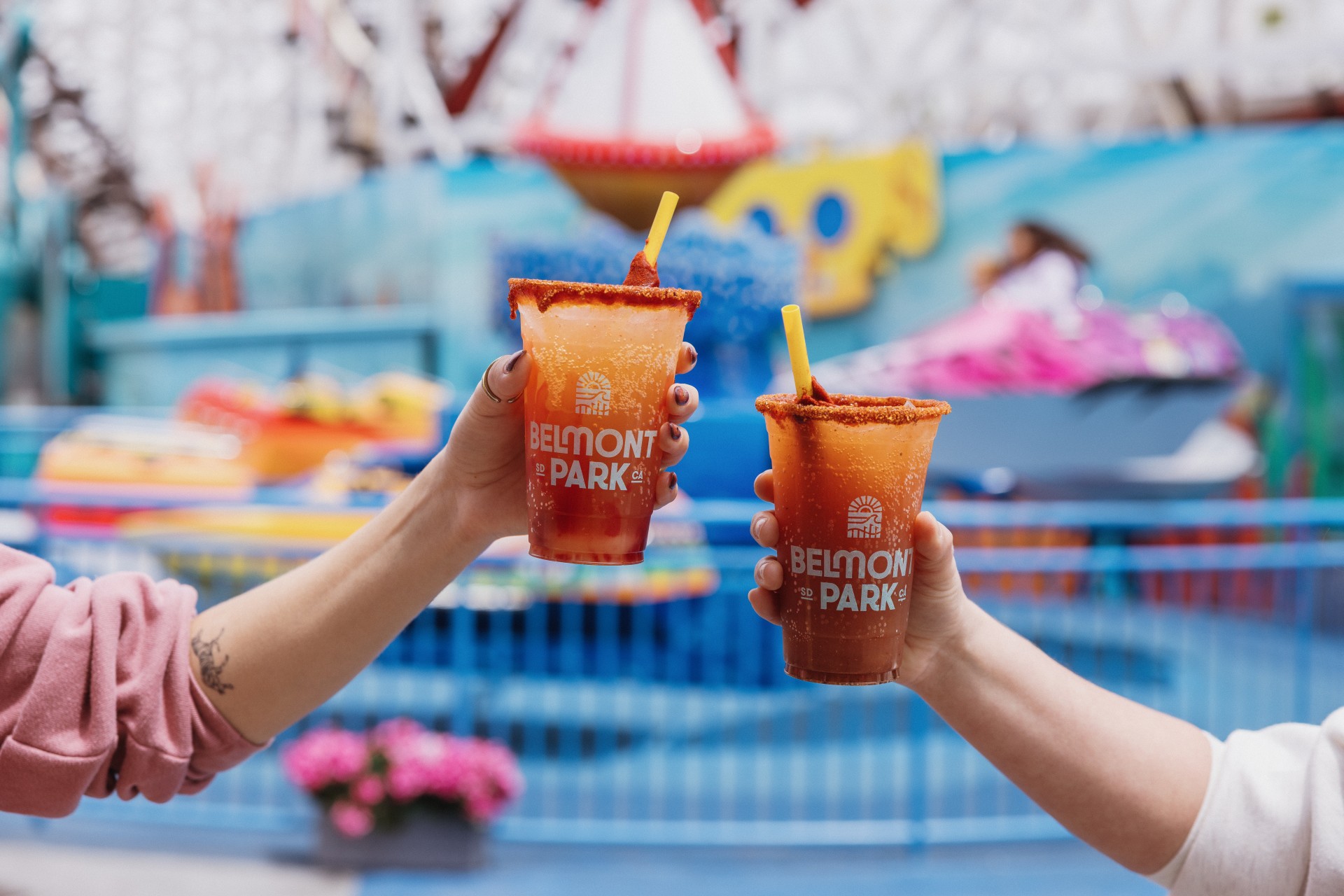 a pair of hands holding micheladas